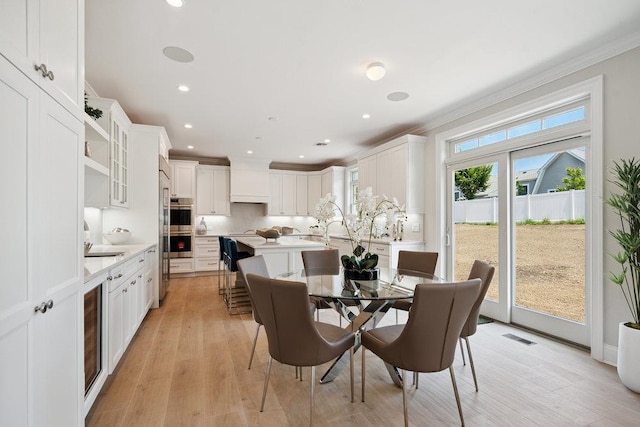 46 Plainview Rd, Woodbury, NY 11797 - dining area with ornamental molding, light wood finished floors, recessed lighting, and wine cooler