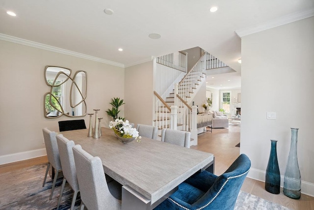 46 Plainview Rd, Woodbury, NY 11797 - dining room with stairs, wood finished floors, ornamental molding, and recessed lighting