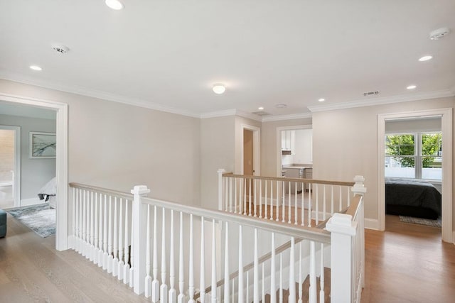 46 Plainview Rd, Woodbury, NY 11797 - hallway with an upstairs landing, wood finished floors, recessed lighting, and crown molding