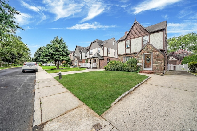 8624 253rd St, Bellerose, NY 11426 - view of front of home featuring stone siding, a residential view, a chimney, and driveway