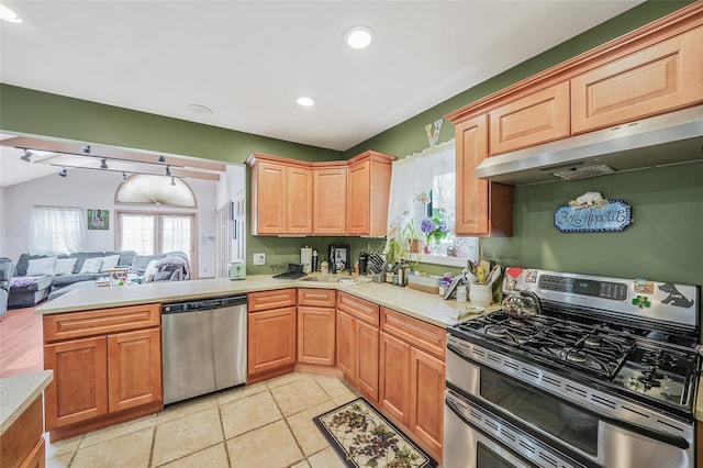 8624 253rd St, Bellerose, NY 11426 - kitchen featuring stainless steel appliances, under cabinet range hood, light countertops, open floor plan, and recessed lighting
