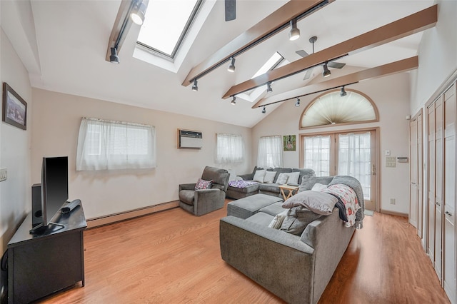 8624 253rd St, Bellerose, NY 11426 - living area with a baseboard radiator, rail lighting, a skylight, lofted ceiling, and light wood-style floors
