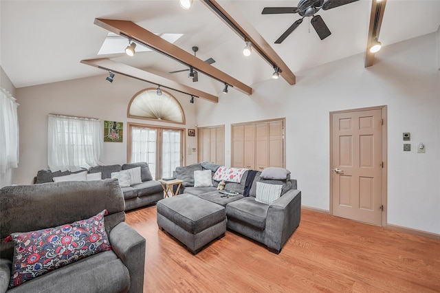 8624 253rd St, Bellerose, NY 11426 - living room with rail lighting, light wood-style floors, ceiling fan, beamed ceiling, and high vaulted ceiling