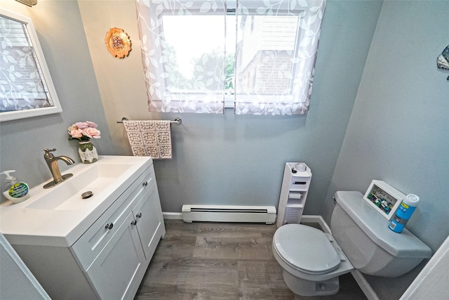8624 253rd St, Bellerose, NY 11426 - bathroom featuring baseboard heating, vanity, and wood finished floors