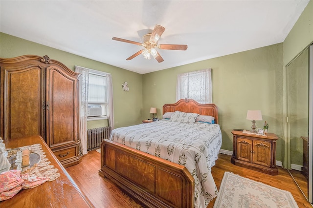 8624 253rd St, Bellerose, NY 11426 - bedroom with radiator heating unit, wood finished floors, ceiling fan, and cooling unit