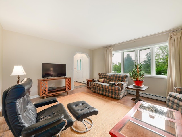 3 Kohler, Middletown, NY 10940 - living area with baseboard heating, arched walkways, and wood finished floors