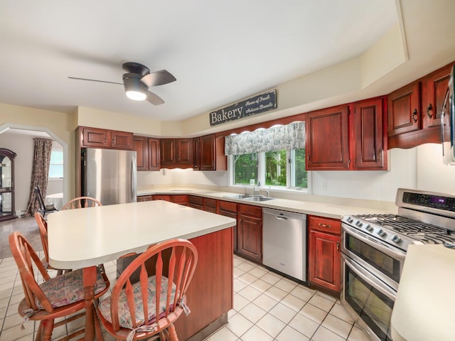 3 Kohler, Middletown, NY 10940 - kitchen featuring appliances with stainless steel finishes, light countertops, a center island, dark brown cabinets, and light tile patterned flooring