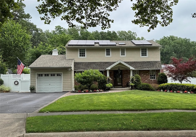 93 Boxwood Dr, Kings Park, NY 11754 - view of front of property with an attached garage, driveway, roof mounted solar panels, and a chimney