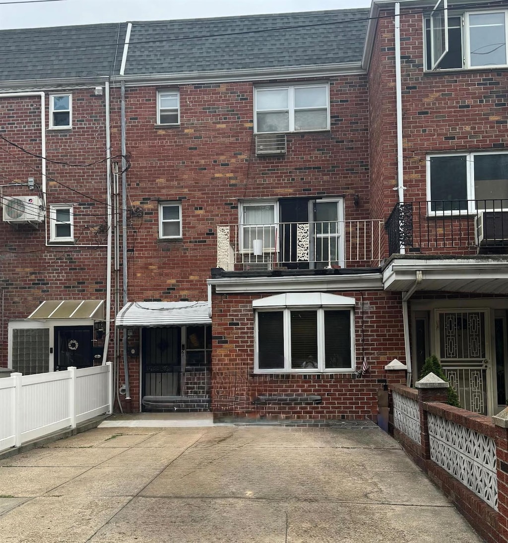 62-56 71st St, Middle Village, NY 11379 - back of property featuring brick siding and roof with shingles