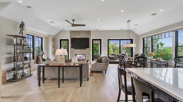 305 Fay Ct, Mattituck, NY 11952 - living room featuring vaulted ceiling, light wood finished floors, ceiling fan, recessed lighting, and a multi sided fireplace