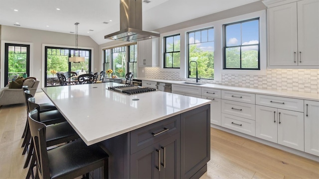305 Fay Ct, Mattituck, NY 11952 - kitchen featuring island exhaust hood, tasteful backsplash, light countertops, light wood-style flooring, and recessed lighting