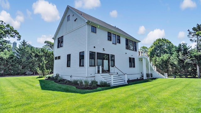 305 Fay Ct, Mattituck, NY 11952 - back of house with a lawn, board and batten siding, and stairway