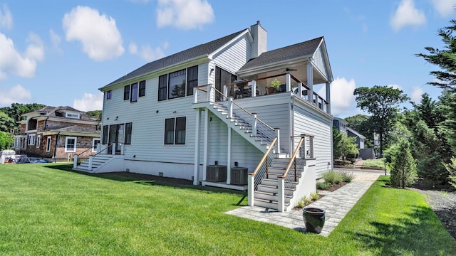 305 Fay Ct, Mattituck, NY 11952 - back of property with stairs, a yard, and a chimney