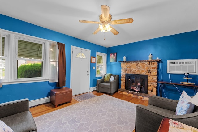 1 Horton Rd, Valley Stream, NY 11581 - living area featuring baseboard heating, a wall mounted AC, wood finished floors, and a ceiling fan