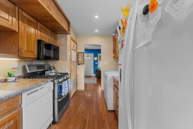 1 Horton Rd, Valley Stream, NY 11581 - kitchen with black microwave, dishwasher, double oven range, independent washer and dryer, and wood finished floors