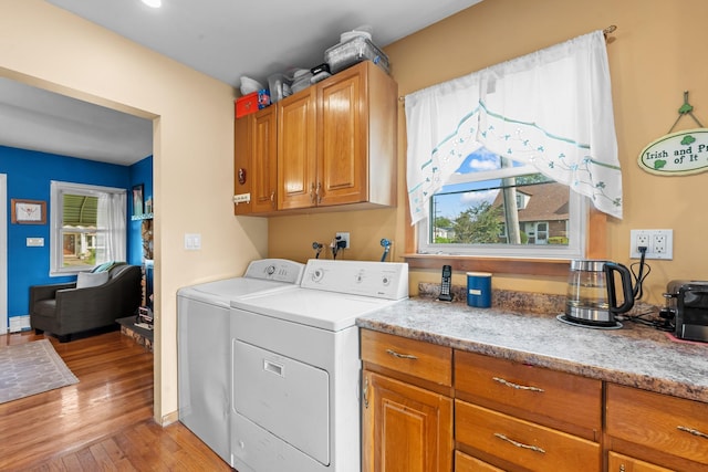 1 Horton Rd, Valley Stream, NY 11581 - washroom featuring washing machine and dryer, light wood-style floors, and cabinet space