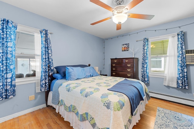 1 Horton Rd, Valley Stream, NY 11581 - bedroom with a baseboard radiator, wood finished floors, and a ceiling fan