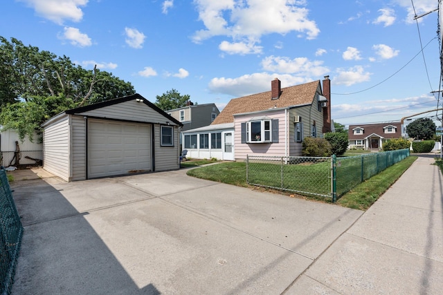 1 Horton Rd, Valley Stream, NY 11581 - view of front of property with driveway, a garage, an outbuilding, and a chimney