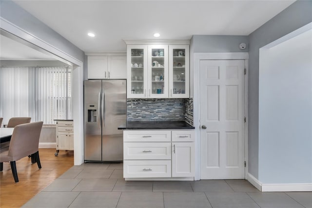 12605 109th Ave, Richmond Hill S, NY 11420 - kitchen with stainless steel refrigerator with ice dispenser, white cabinets, glass insert cabinets, light tile patterned flooring, and tasteful backsplash