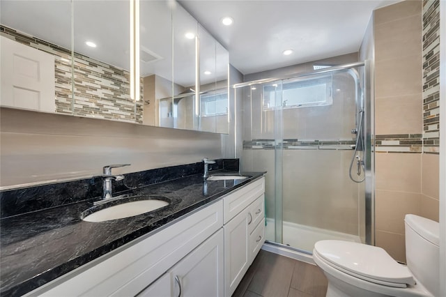 12605 109th Ave, Richmond Hill S, NY 11420 - full bathroom featuring double vanity, a shower stall, and backsplash