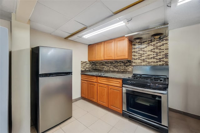 12605 109th Ave, Richmond Hill S, NY 11420 - kitchen with appliances with stainless steel finishes, backsplash, dark stone counters, and a paneled ceiling