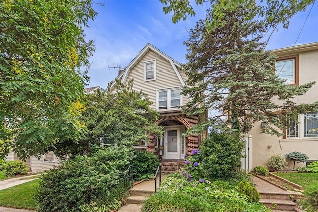 16608 Cryders Ln, Beechhurst, NY 11357 - view of front of home featuring a gambrel roof, brick siding, and stucco siding