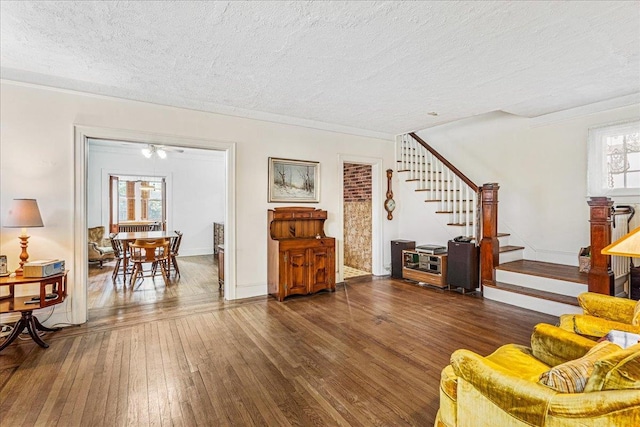 16608 Cryders Ln, Beechhurst, NY 11357 - living area with a textured ceiling, stairs, hardwood / wood-style floors, and crown molding