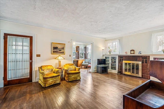 16608 Cryders Ln, Beechhurst, NY 11357 - living area with healthy amount of natural light, wood-type flooring, a brick fireplace, a textured ceiling, and crown molding