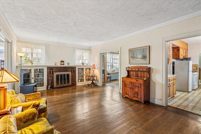 16608 Cryders Ln, Beechhurst, NY 11357 - living room featuring wood-type flooring, a textured ceiling, a fireplace, and crown molding