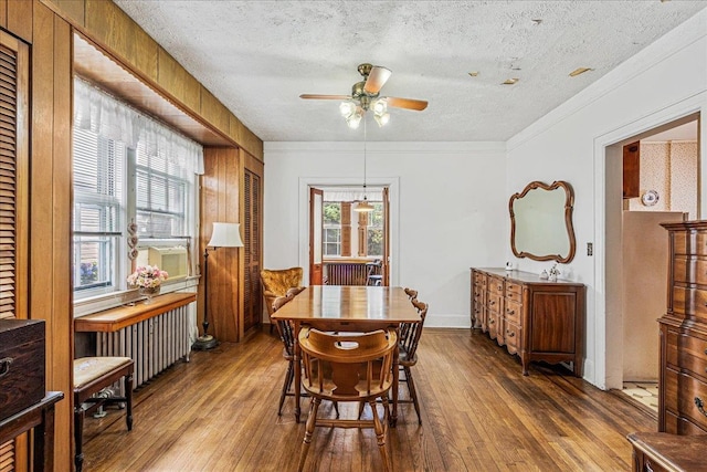 16608 Cryders Ln, Beechhurst, NY 11357 - dining area featuring a ceiling fan, dark wood-type flooring, a textured ceiling, radiator heating unit, and ornamental molding