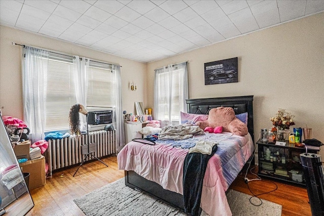 16608 Cryders Ln, Beechhurst, NY 11357 - bedroom with radiator and wood finished floors