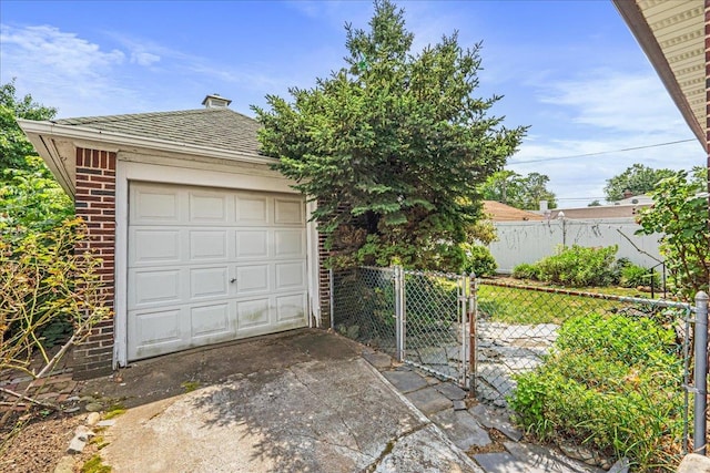 16608 Cryders Ln, Beechhurst, NY 11357 - detached garage featuring driveway and a gate