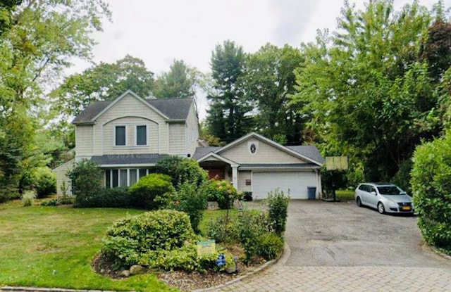 18 Locust Ln, Roslyn Heights, NY 11577 - view of front facade with driveway, a garage, a front yard, and view of scattered trees