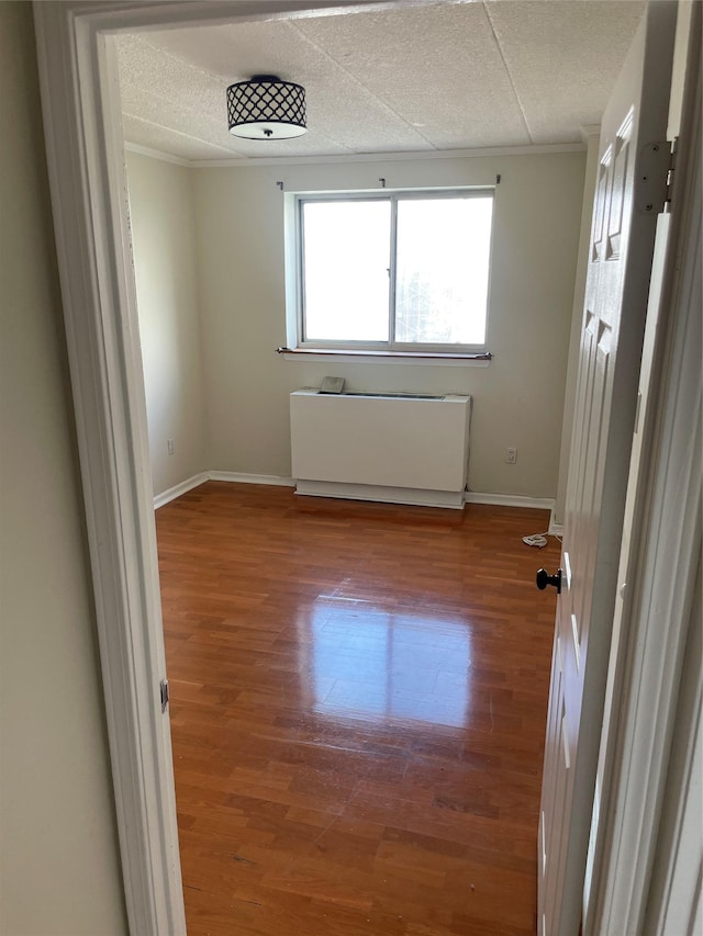 3220 Fairfield Ave Unit 6D, Bronx, NY 10463 - unfurnished room with radiator heating unit, wood finished floors, and crown molding