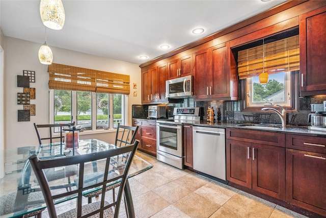 1334 Thompson Dr, Bay Shore, NY 11706 - kitchen with appliances with stainless steel finishes, decorative backsplash, hanging light fixtures, recessed lighting, and light tile patterned floors