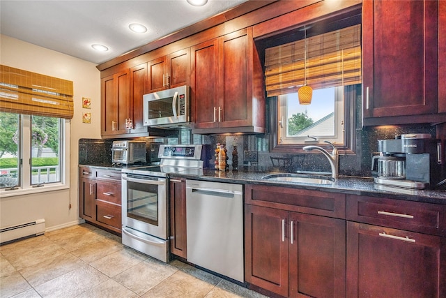 1334 Thompson Dr, Bay Shore, NY 11706 - kitchen featuring appliances with stainless steel finishes, decorative backsplash, dark stone counters, light tile patterned floors, and a baseboard radiator