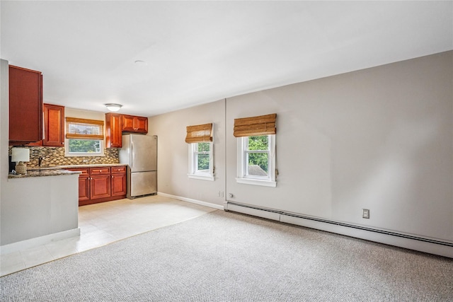 1334 Thompson Dr, Bay Shore, NY 11706 - kitchen featuring freestanding refrigerator, a baseboard radiator, plenty of natural light, and decorative backsplash