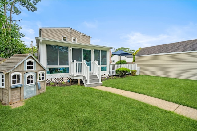 1334 Thompson Dr, Bay Shore, NY 11706 - back of property with a sunroom, a storage shed, and a lawn
