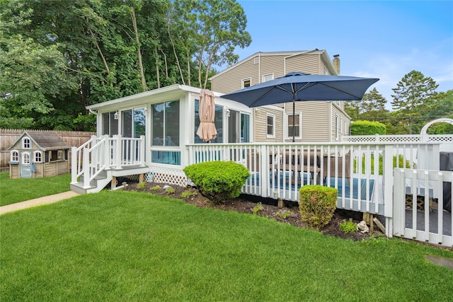1334 Thompson Dr, Bay Shore, NY 11706 - rear view of property featuring a sunroom, a chimney, a pool, and a storage shed