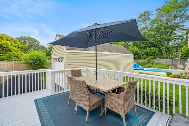 1334 Thompson Dr, Bay Shore, NY 11706 - wooden deck featuring a fenced backyard, a garage, outdoor dining space, and an outdoor structure