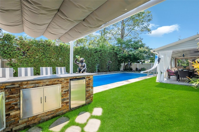 318 Claremont Ave, West Babylon, NY 11704 - view of swimming pool featuring a water slide, a fenced backyard, and a patio