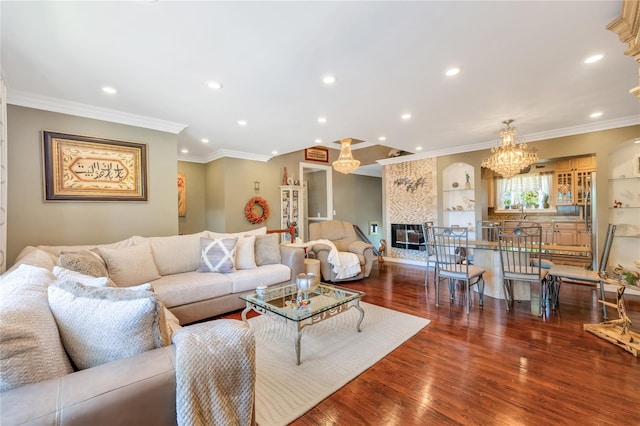 318 Claremont Ave, West Babylon, NY 11704 - living room featuring recessed lighting, wood finished floors, a chandelier, and ornamental molding