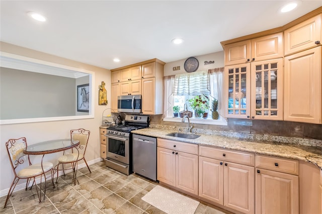 318 Claremont Ave, West Babylon, NY 11704 - kitchen with stainless steel appliances, light brown cabinets, light stone countertops, glass insert cabinets, and recessed lighting