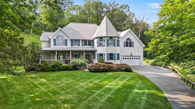 8 Hamlet Way, Hopewell Junction, NY 12533 - victorian home with an attached garage, asphalt driveway, stucco siding, and a front lawn