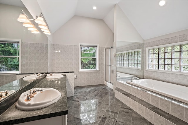 8 Hamlet Way, Hopewell Junction, NY 12533 - bathroom with tile walls, a bath, double vanity, a stall shower, and lofted ceiling