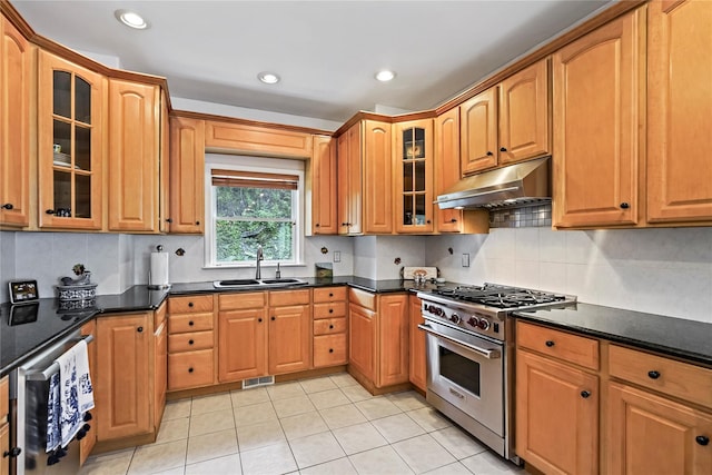 8 Hamlet Way, Hopewell Junction, NY 12533 - kitchen featuring high end stove, under cabinet range hood, light tile patterned flooring, decorative backsplash, and glass insert cabinets
