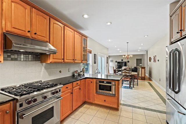 8 Hamlet Way, Hopewell Junction, NY 12533 - kitchen featuring appliances with stainless steel finishes, under cabinet range hood, light tile patterned flooring, tasteful backsplash, and recessed lighting