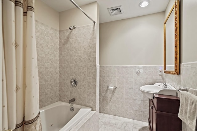 8 Hamlet Way, Hopewell Junction, NY 12533 - full bath with tile walls, vanity, shower / bath combo with shower curtain, wainscoting, and marble look tile flooring