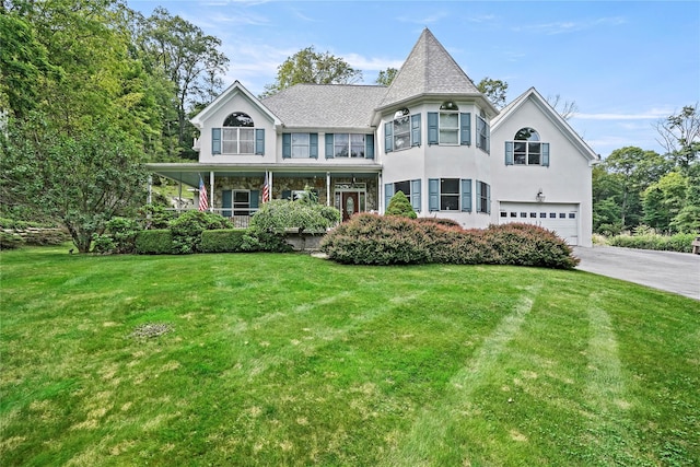 8 Hamlet Way, Hopewell Junction, NY 12533 - victorian house featuring an attached garage, concrete driveway, a front yard, stucco siding, and a porch