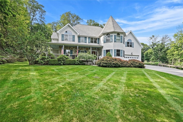 8 Hamlet Way, Hopewell Junction, NY 12533 - victorian-style house featuring driveway, a garage, a front lawn, a porch, and stucco siding